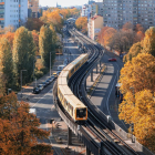 Urban canyon: Railroad tracks, skyscrapers, autumn trees