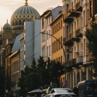 Surreal street scene with doughnut decorations and scattered pastel sky.