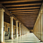 Opulent corridor with golden columns and blue arches