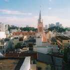 Colorful Townscape with Pastel Buildings, Canal, and Eiffel Tower-like Tower