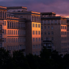 Twilight city skyline with illuminated buildings and full moon