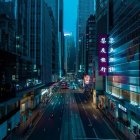 Urban twilight scene: city street with neon lights, cars, and trees against blue sky