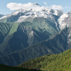 Mountain village landscape with rolling hills and clear sky