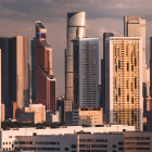 Cityscape illustration: Sunset scene with skyscrapers, birds, and warm hues