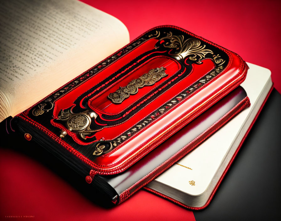 Red and Black Leather Journal with Gold Detailing on Red Background