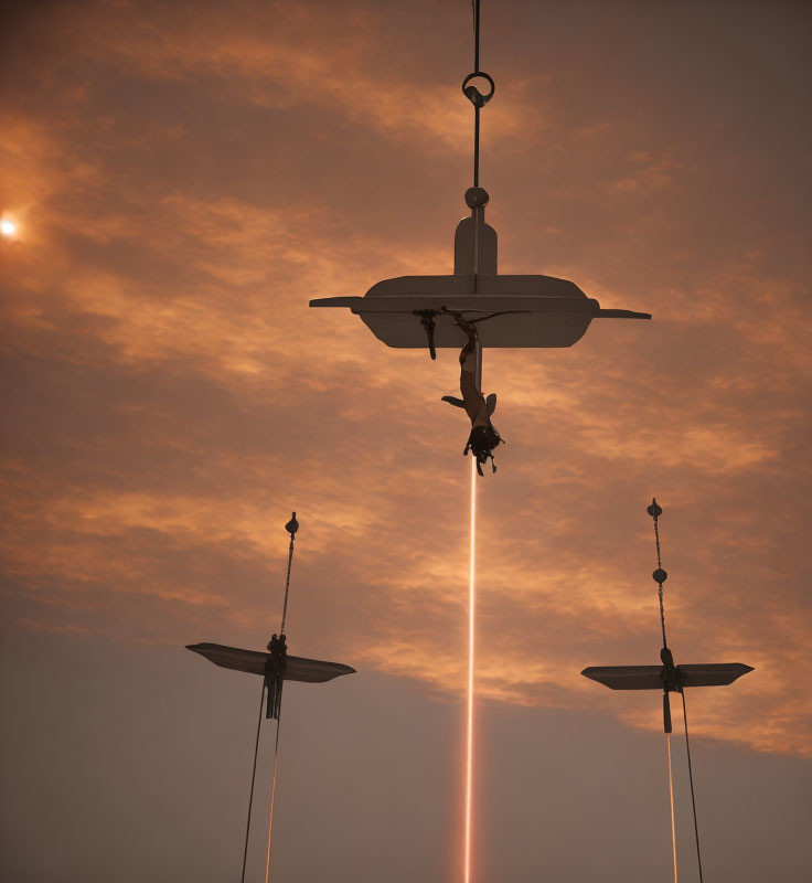 Drone emitting light against sunset sky with smaller drones in orange clouds