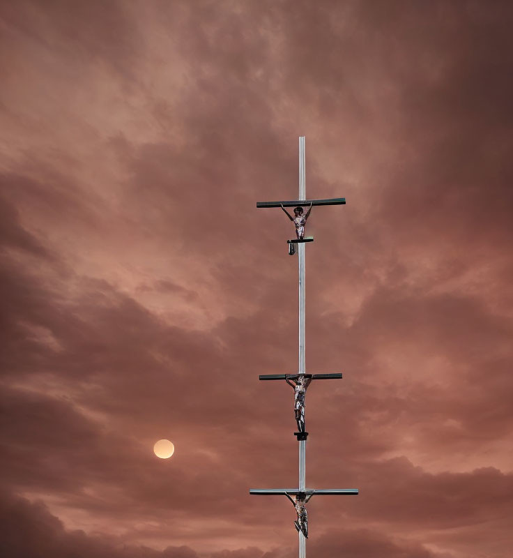 Religious cross with figures on dramatic orange sky and sun.