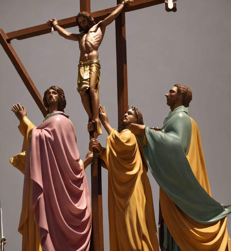 Religious statues depicting crucifixion scene with three figures.