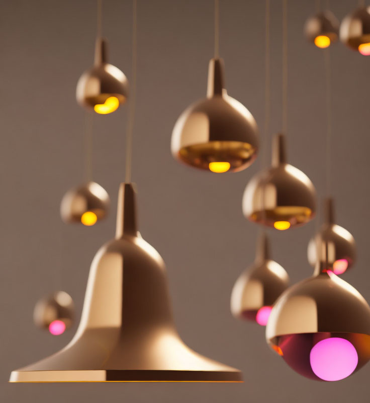 Metallic Finish Pendant Lights Against Soft Grey Background - Warm Glowing Interiors