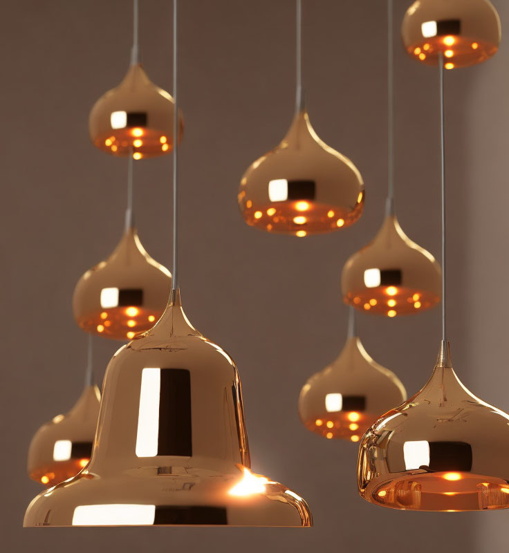 Warm Glowing Copper Pendant Lights Suspended Against Neutral Backdrop