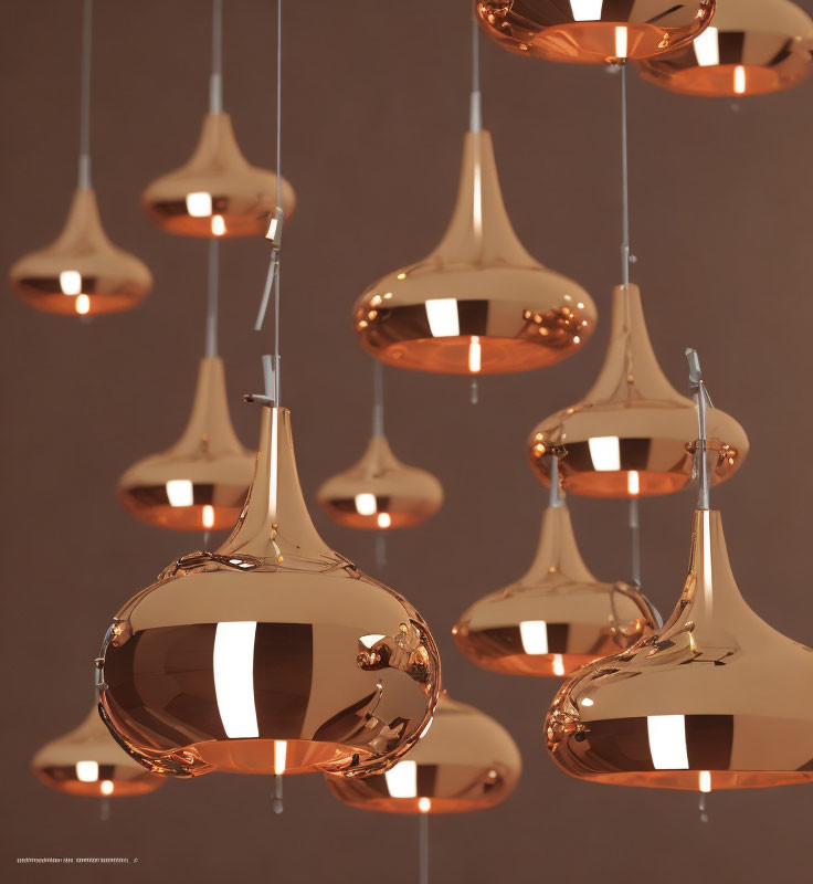 Polished Copper Pendant Lights Hanging at Varying Heights