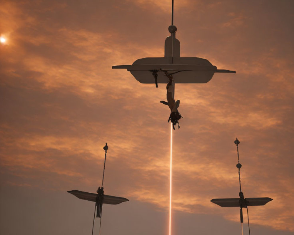 Drone emitting light against sunset sky with smaller drones in orange clouds