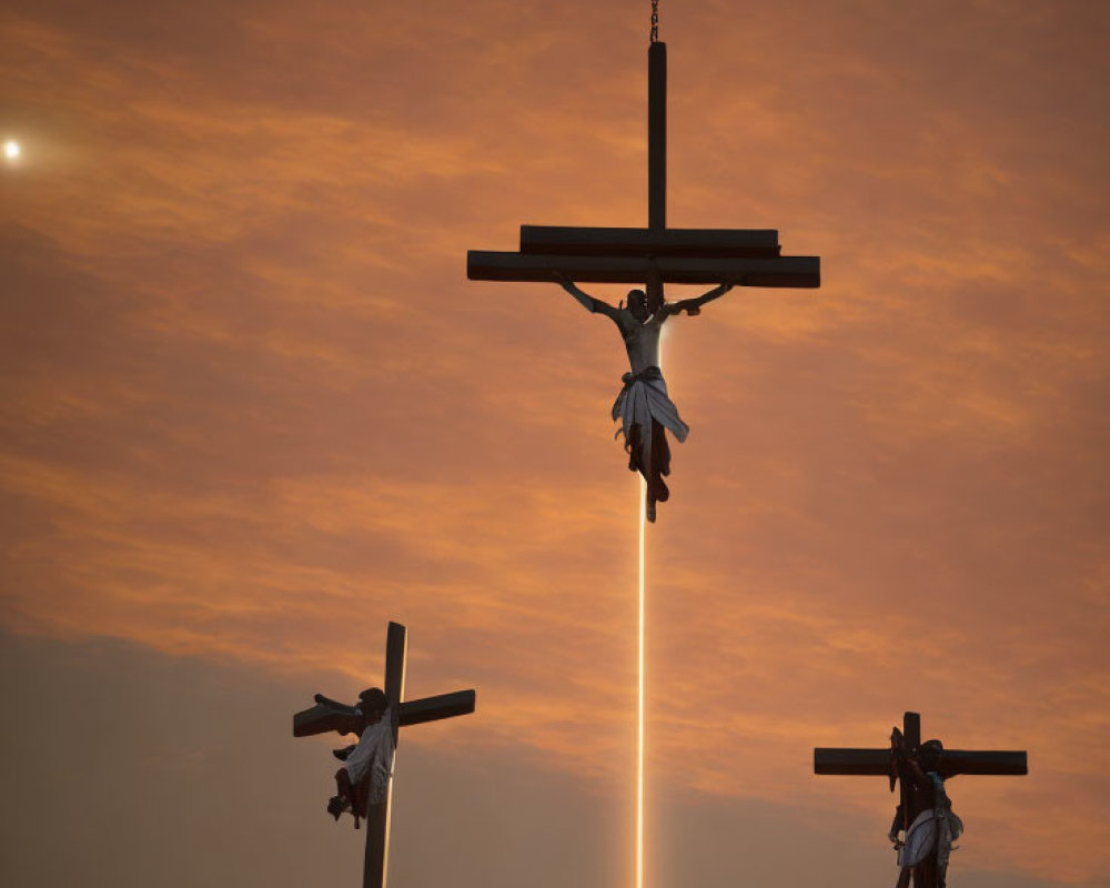 Religious scene: Three crosses at sunset with figures and divine light.