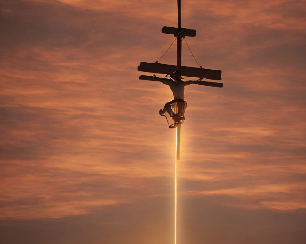 Airplane with contrail in orange-tinted sunset sky