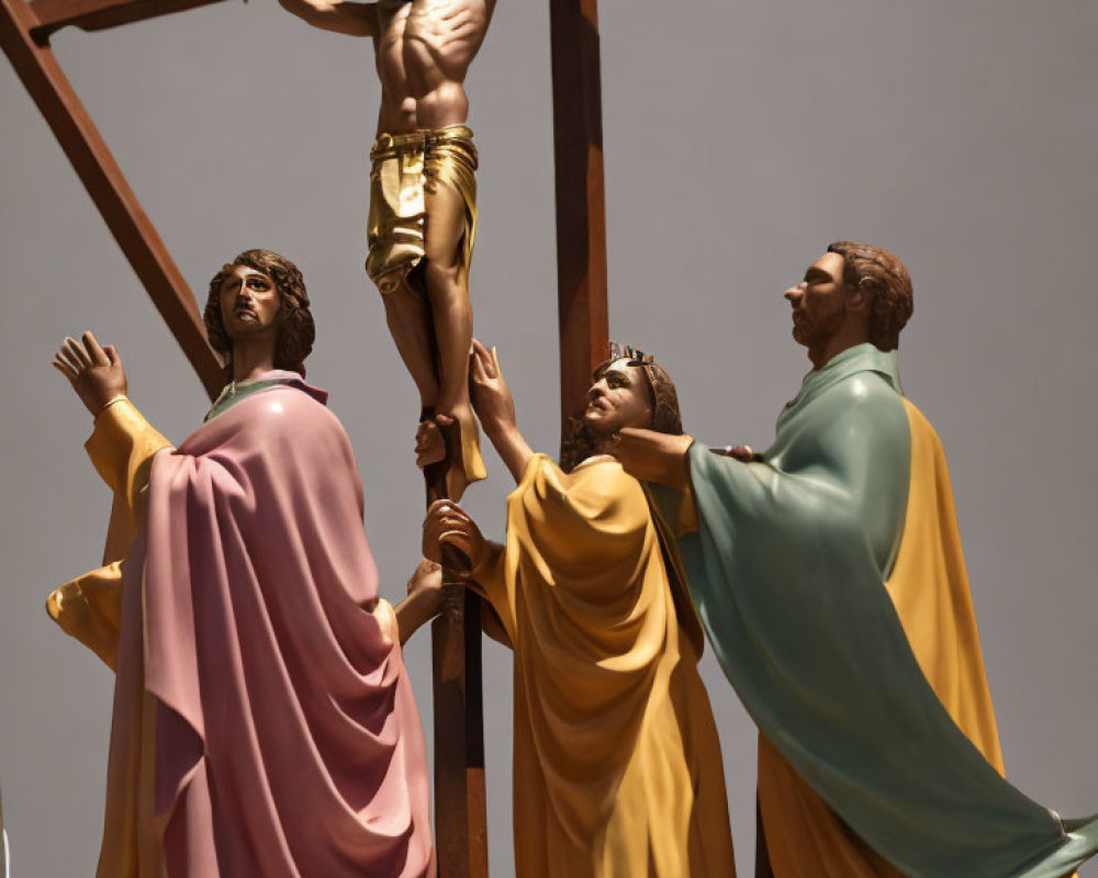 Religious statues depicting crucifixion scene with three figures.