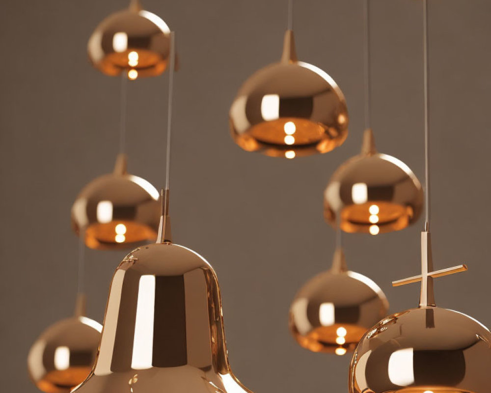 Various Shapes Copper Pendant Lights Emitting Warm Glow on Neutral Background