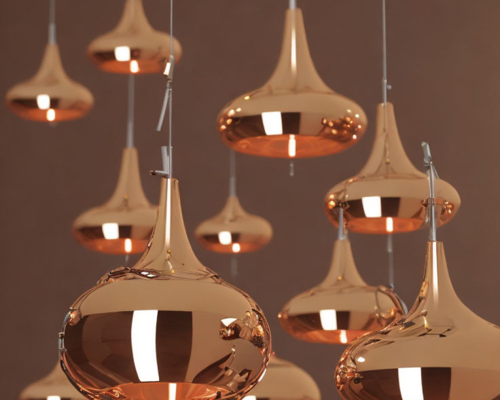 Polished Copper Pendant Lights Hanging at Varying Heights