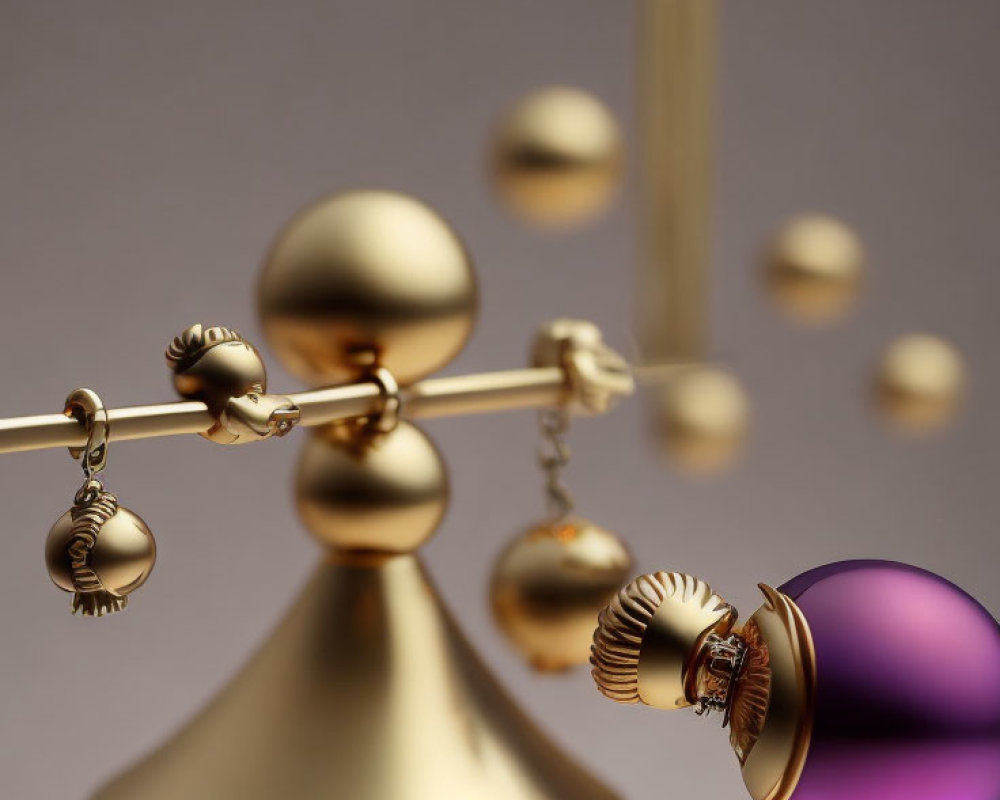 Gold Kinetic Balance Sculpture with Hanging Spheres and Purple Reflective Sphere