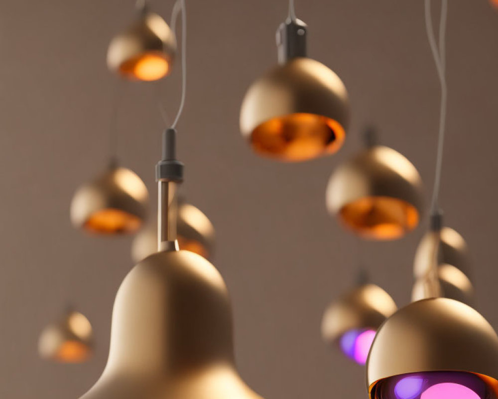 Matte Gold Pendant Lights Hanging at Various Heights on Neutral Background