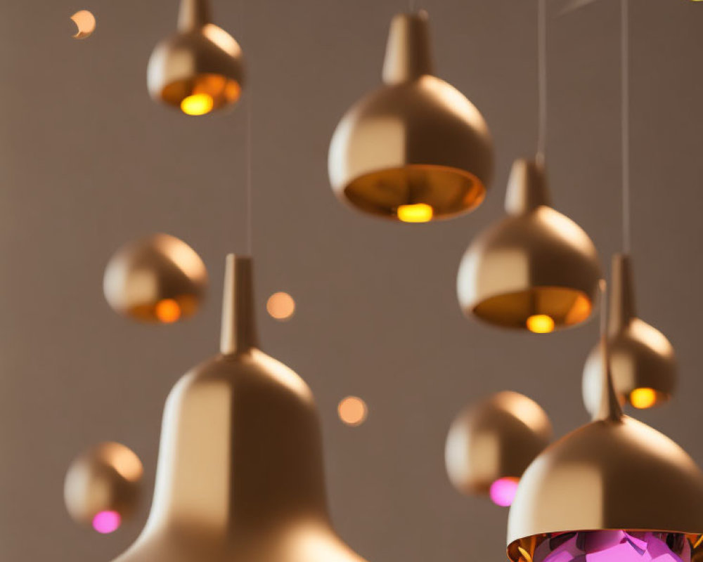 Metallic finish modern pendant lights emit warm glow against neutral backdrop.