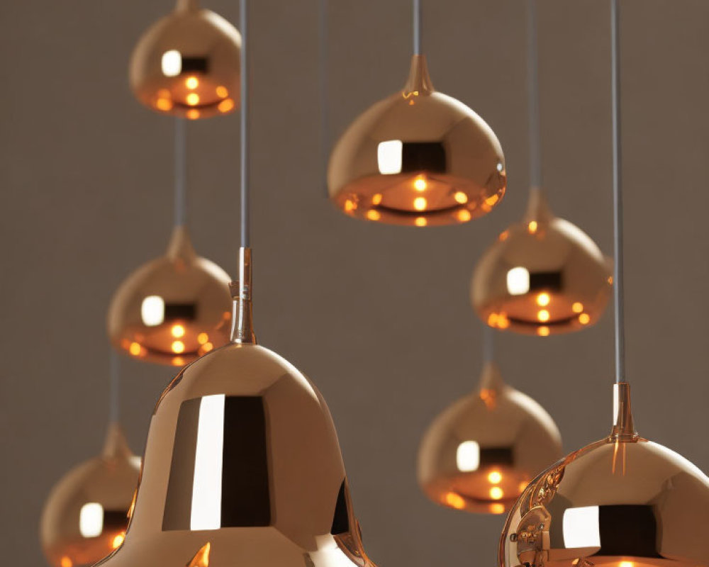 Contemporary Copper Pendant Lights in Varied Heights on Neutral Background