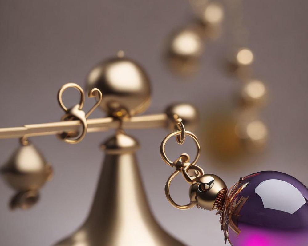 Golden balance scale with violet sphere and golden band on blurred background.