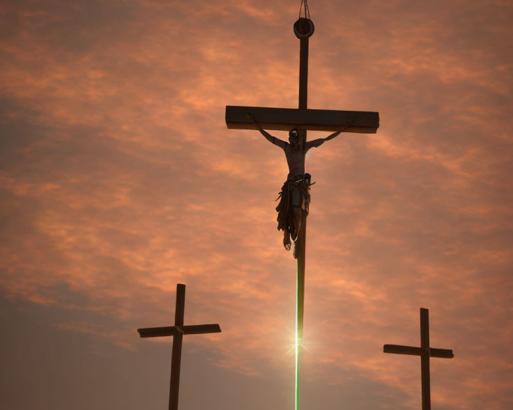 Silhouetted crosses against orange sky with central figure.