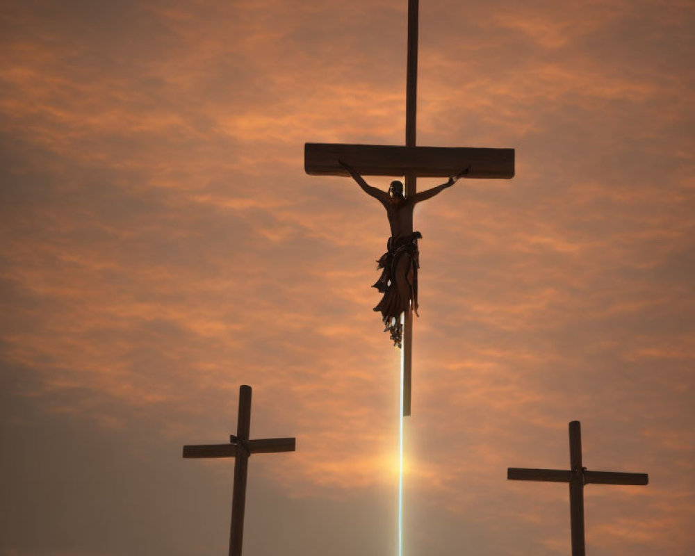 Three Crosses Silhouetted Against Dramatic Sunset Sky