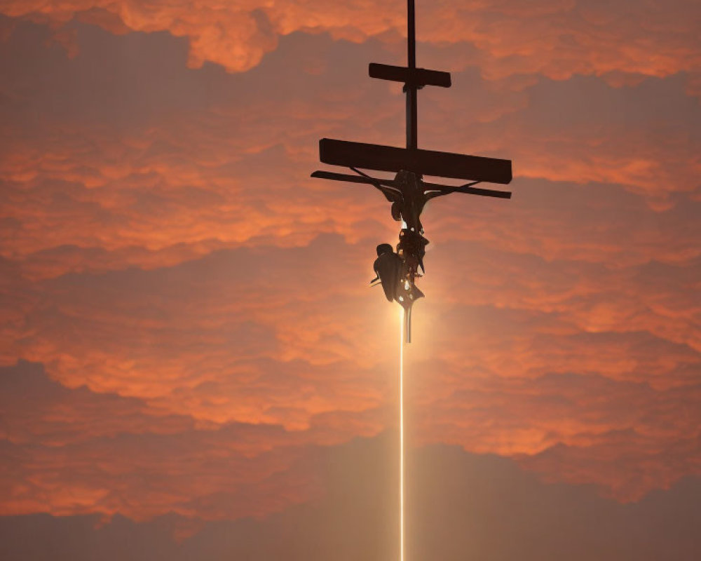 Helicopter silhouette against fiery sunset with bright beam.