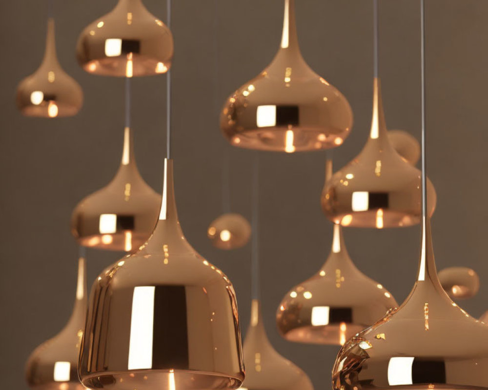 Glossy copper pendant lights on neutral background