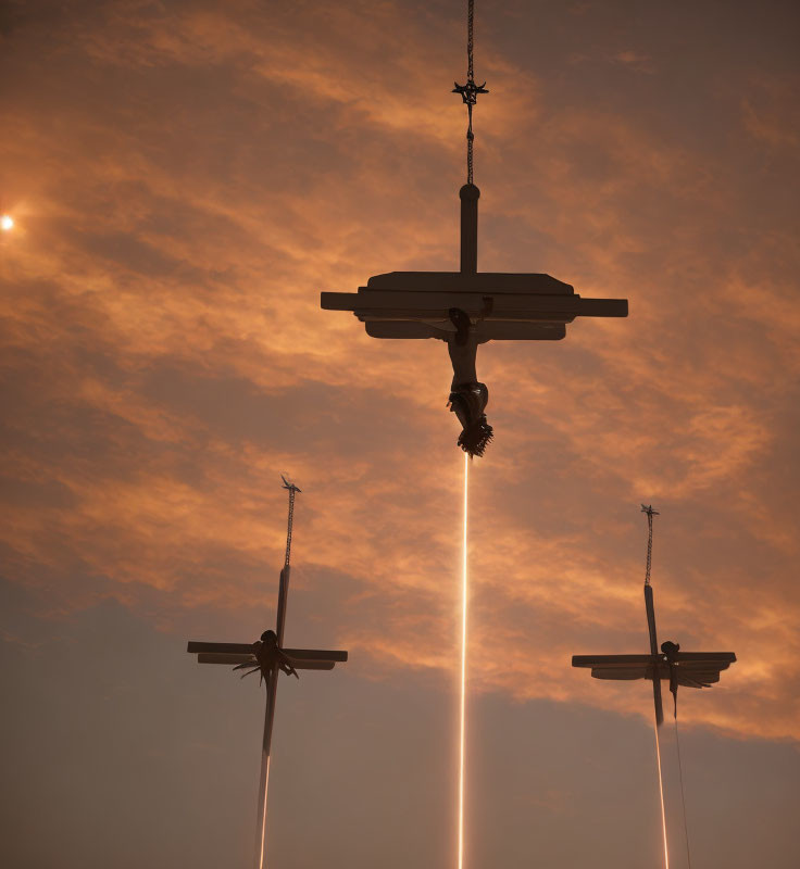 Silhouetted figures on three crosses under dramatic sky