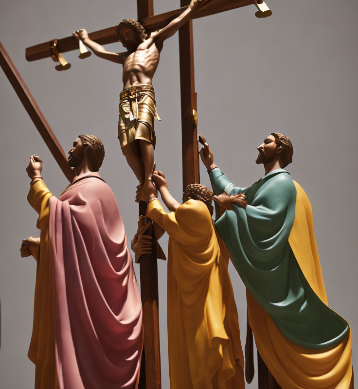 Three statues of biblical scene with figures looking up at cross