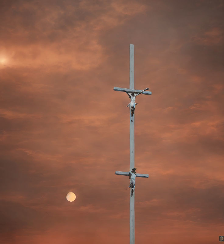 Religious crucifix with three figures under orange sky and moon