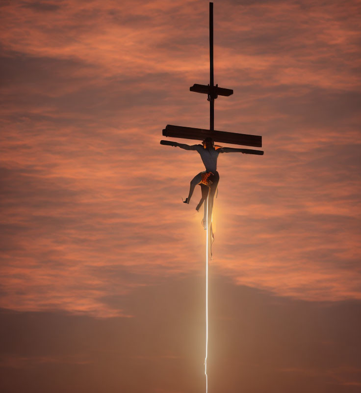 Person suspended on cross-shaped structure under dramatic orange sky