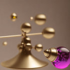 Purple Glass Perfume Bottle with Gold Atomizer on Golden Bell and Floating Bells on Beige Background