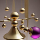 Elegant kinetic mobile with golden and purple spheres, featuring a toppled purple ball on a chain