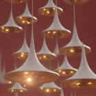 Unique Inverted Teardrop Pendant Lights: White exterior, golden interior, against dark red background