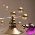 Golden balance scale with brass bell and purple glass perfume bottle