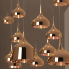 Glossy copper pendant lights on neutral background