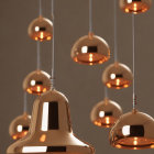 Contemporary Copper Pendant Lights in Varied Heights on Neutral Background