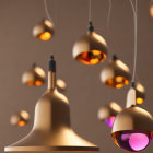 Bronze finish pendant lights in varying heights against neutral backdrop