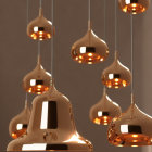 Warm Glowing Copper Pendant Lights Suspended Against Neutral Backdrop