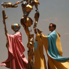 Colorful Crucifixion Statues with Two Figures in Robes