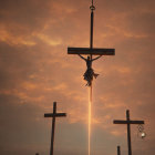 Three Crosses Silhouetted Against Dramatic Sunset Sky