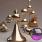 Balance mobile sculpture with golden and purple spheres.