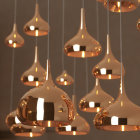 Reflective Gold Pendant Lights on Gray Background for Luxurious Ambiance