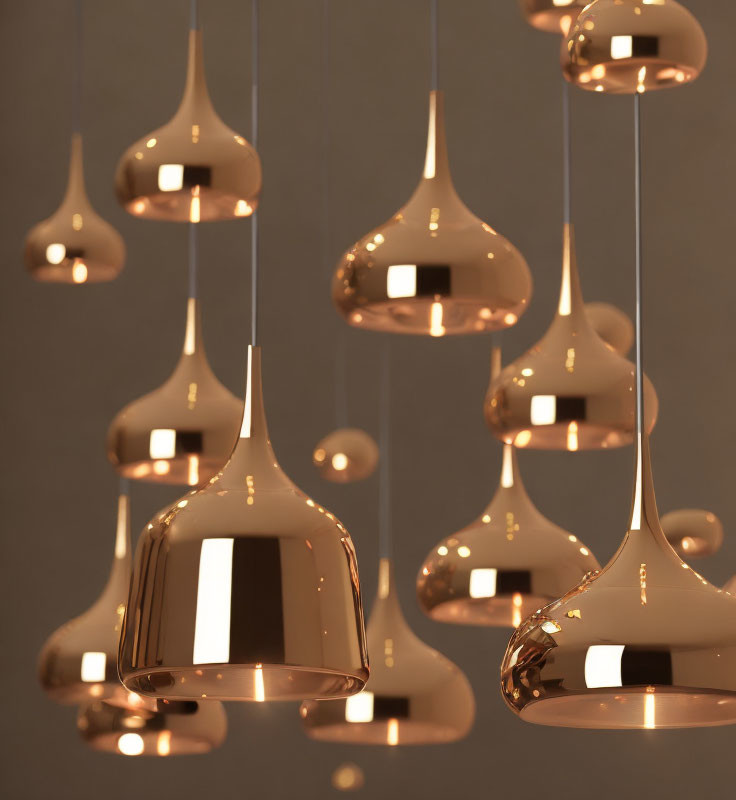 Glossy copper pendant lights on neutral background