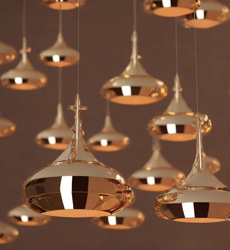 Reflective modern copper pendant lights on soft brown background