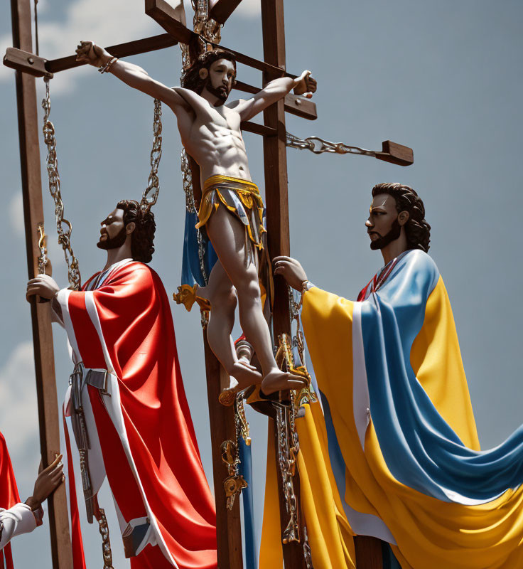 Religious statues of Jesus Christ crucifixion with two others under cloudy sky