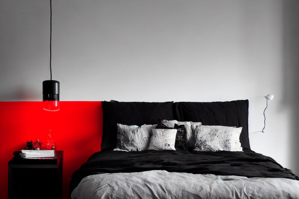 Monochrome bedroom with red accent wall and stylish decor